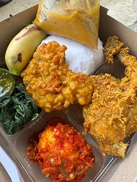 Nasi ayam goreng + telur + perkedel + buah + sayur + sambal